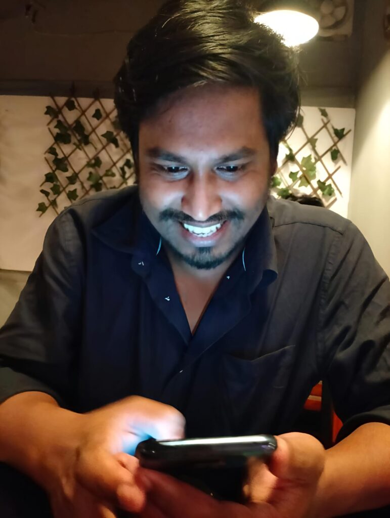 Mizanur Rahaman Watching Successful Results of SEO Ranking in His Mobile Phone while having Coffee at a Restaurant